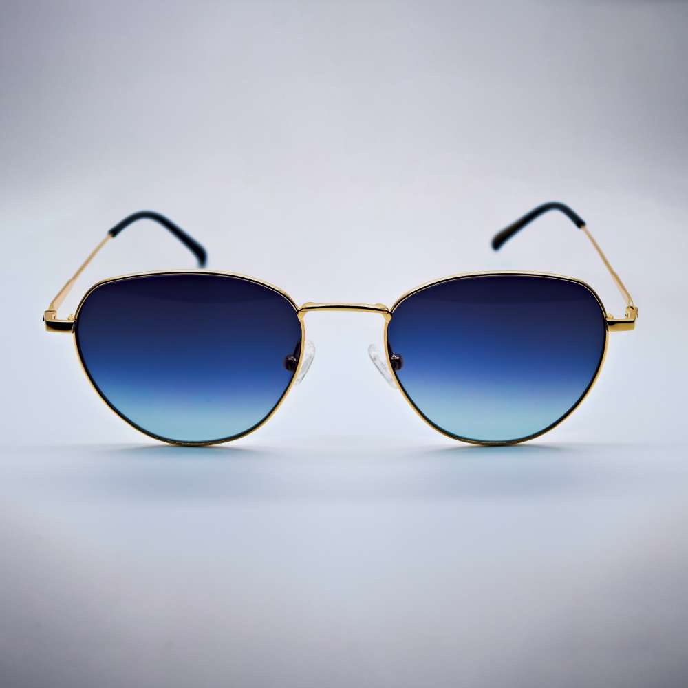 Sunglasses with gold frame and blue gradient lenses on a gray background #desktop-half for half-width
