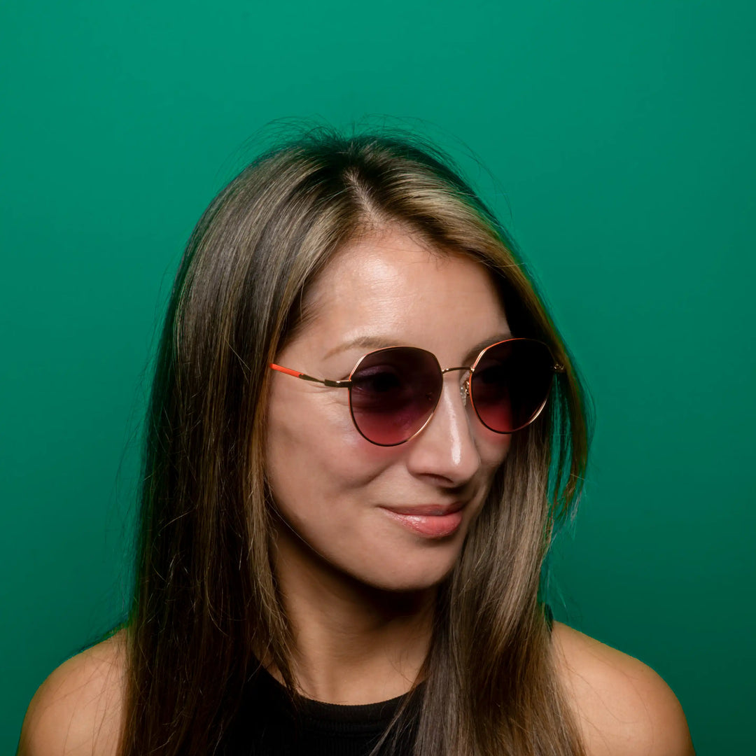 Woman wearing sunglasses with a green background #desktop-half for half-width