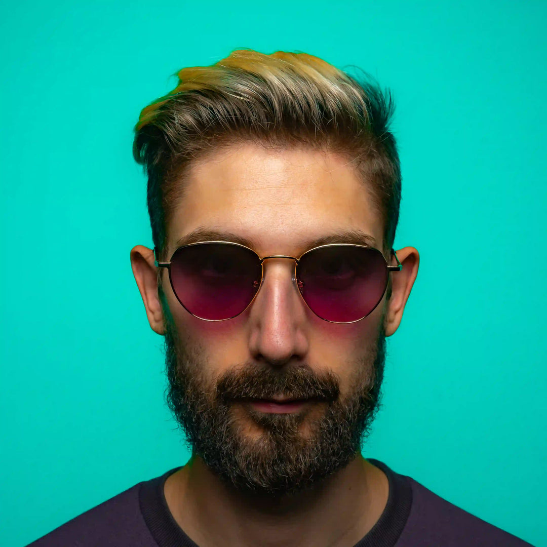A man wearing luxury sunglasses with pink purple lens color
